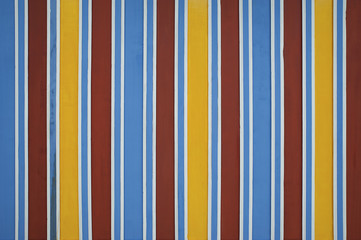 Brightly colored ceiling in traditional tones spotted in Marrakesh, Morocco. Vibrant color stripes background, in traditional Moroccan architecture.