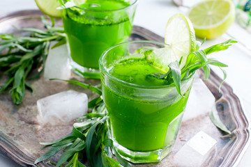 Two glass glasses with a drink from the leaves of the tarragon, horizontal