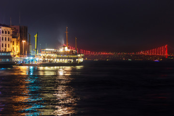 Fototapeta na wymiar View of Galata quarter on the Bosporus and a bridge in the distance at night. Istanbul. Turkey.