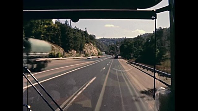 Vintage footage, point of view of a tourist bus driving on the highway to Jerusalem city on 80s, Israel. Historic restored footage on 1980s.