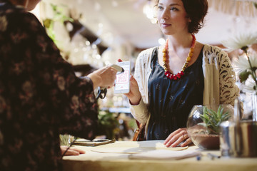 Owner scanning QR code of customer in plant shop