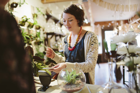 Owner scanning QR code of customer in plant shop