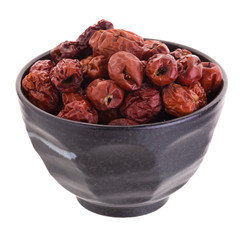 Dried jujube fruits in ceramic bowl chinese herbal medicine on a white background