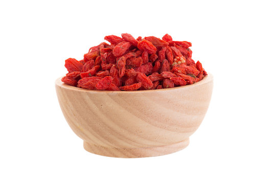 Goji berries in wooden bowl isolated on white background