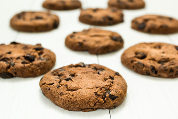 Chocolate cookies on a white wooden table.