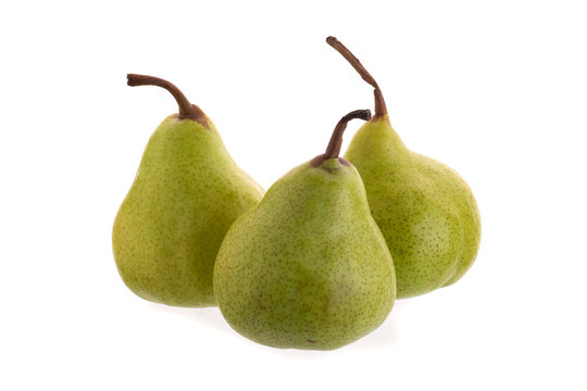Close up of fresh green pears over white background