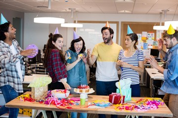 Creative business team celebrating colleagues birthday
