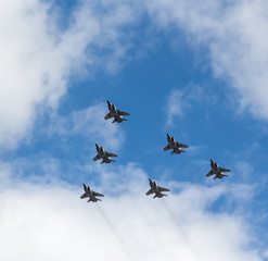 Naklejka na ściany i meble War planes in blue sky with clouds at the victory parade in the capital of Kazakhstan Astana in 2017