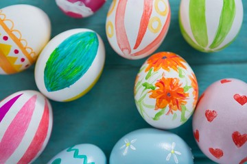 Painted Easter eggs on wooden surface