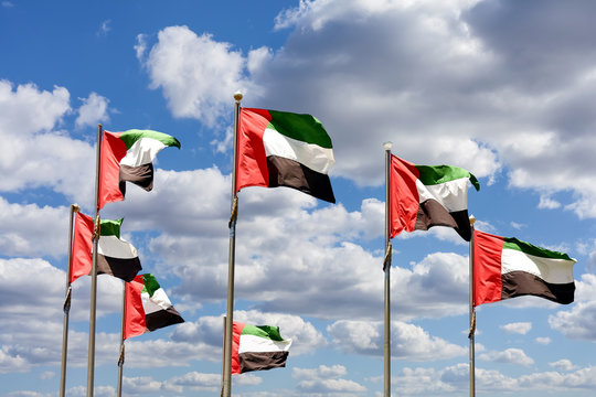 Seven United Arab Emirates flags represent federation of seven emirates.