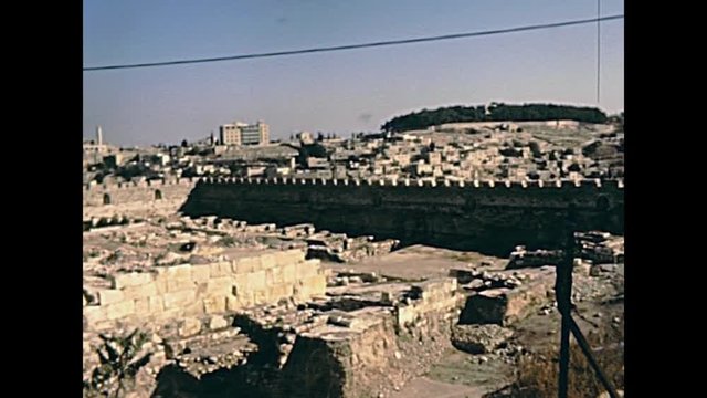 Old City of Jerusalem wall panorama. With the As-Sakhrah Mosque on the Temple Mount. Historic restored footage on 1980s in Israel.