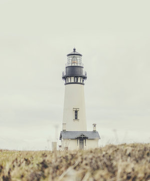 Surface level of lighthouse on field against sky