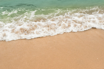 Fototapeta na wymiar background of blue wave on the sandy beach