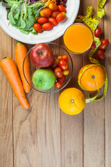 Healthy concept with mixed fruits and vegetables on wooden background