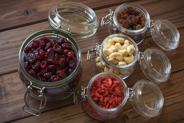 Healthy food / dried fruits, seeds and nuts on wooden table background.