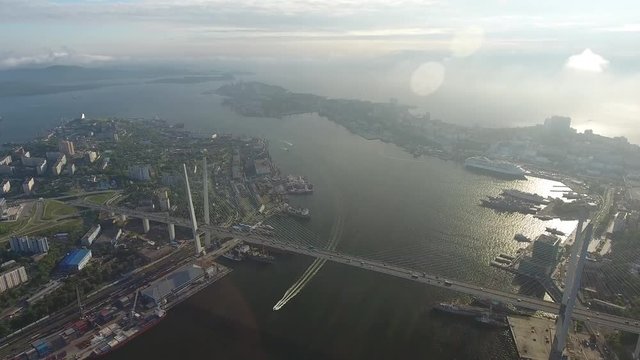 High altitude flight above Golden Bridge cable-stayed Zolotoy Rog built for APEC summit. Vladivostok, far east of Russia. Best unique Aerial drone helicopter flight 4k footage. Summer day. Horizon sea
