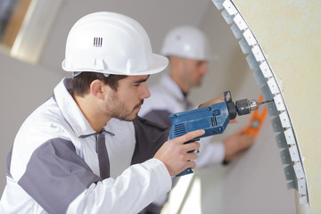 construction worker with tools and drill renovating house