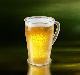 A glass of beer on a green background.