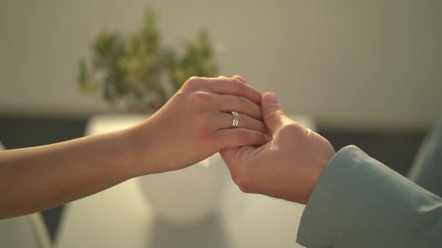 4k video detail couple in love holding hands outside on terrace
