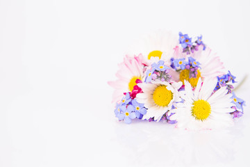 Daisies and forget-me-nots bouquet on a white background