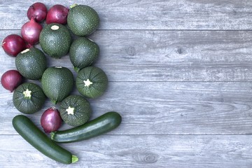 Fresh vegetables on a wooden table and cutting board.