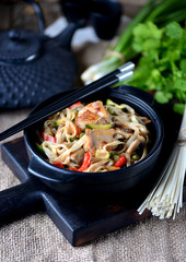 Udon noodles with chicken, pepper, carrots, onions, zucchini and mushrooms in teriyaki sauce. Asian cuisine.