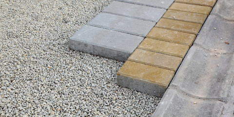 Installing of concrete brick pavement to gravel foundation