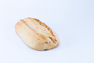 Rustic loaf of wheat bread isolated on white background