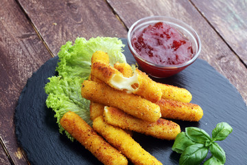 Breaded mozzarella cheese sticks with tomato ketchup and bbq sauce