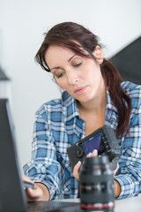 pretty technician examining dslr camera