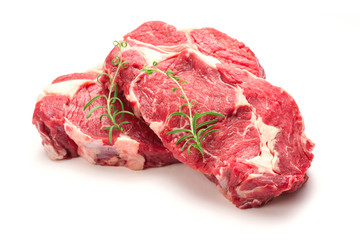 Raw steaks isolated on white background