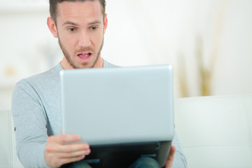 man work on laptop surprise