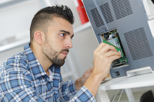Man replacing battery in appliance