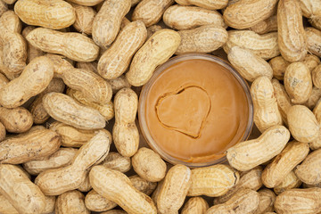 Peanut butter and raw peanuts in shells