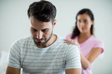 Upset couple sitting on bed in the bedroom