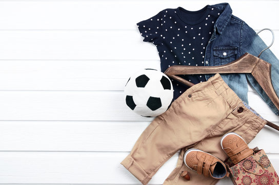 Baby Boy Clothing Set (blue T-shirt With White Stars, Jeans Shirt, Brown Shoes, Pant). Wish List Or Shopping Overview For Pregnancy And Baby Shower. View From Above.