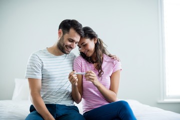 Joyful couple finding results of a pregnancy test 