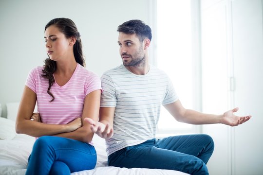 Couple arguing with each other in bedroom