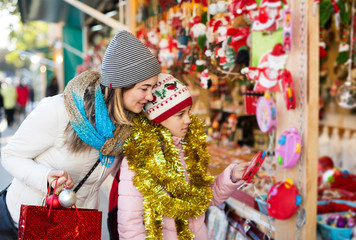 Fototapeta na wymiar Girl with mom buying decorations