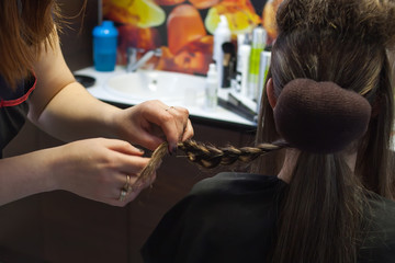 Fototapeta premium A women with long hair. A hairdresser with a client