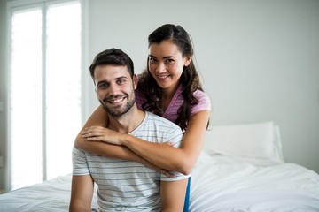 Portrait of couple embracing each other in bedroom