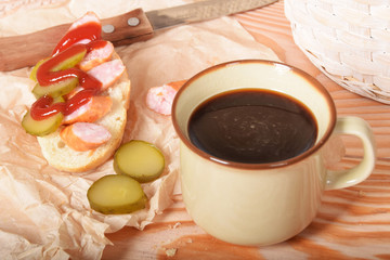 Quick sandwich with cucumber sausage and ketchup on paper