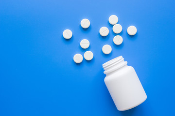medicine set with meds on doctor's workplace blue background top view mockup