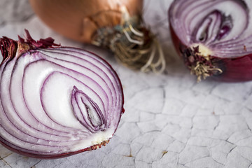 Fresh onions on old white wooden table