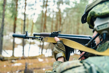 Automatic weapons in the hands of a soldier of the Russian army during a combat operation, against...