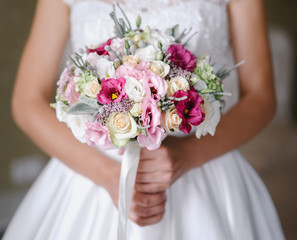 Obraz na płótnie Canvas Bride with a beautiful purple wedding bouquet