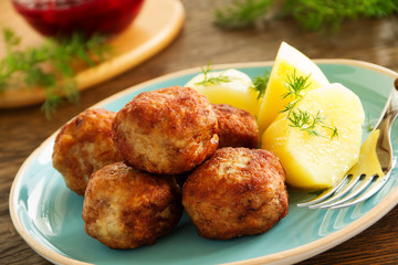 Hot meatballs with boiled potatoes and cranberry sauce ..
