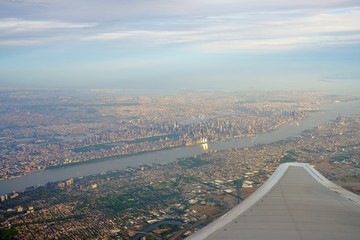Fototapeta na wymiar Aerial view of the Manhattan skyline in New York City seen from an airplane window 