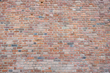 Fototapeta premium Red bricks wall background. Wall of old building useful as backdrop.