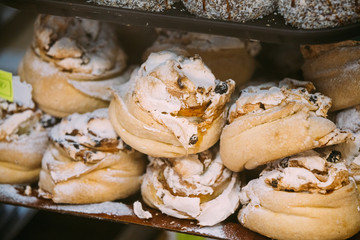 Sweet Cakes With White Custard Cream In Pastry Shop Glass Display